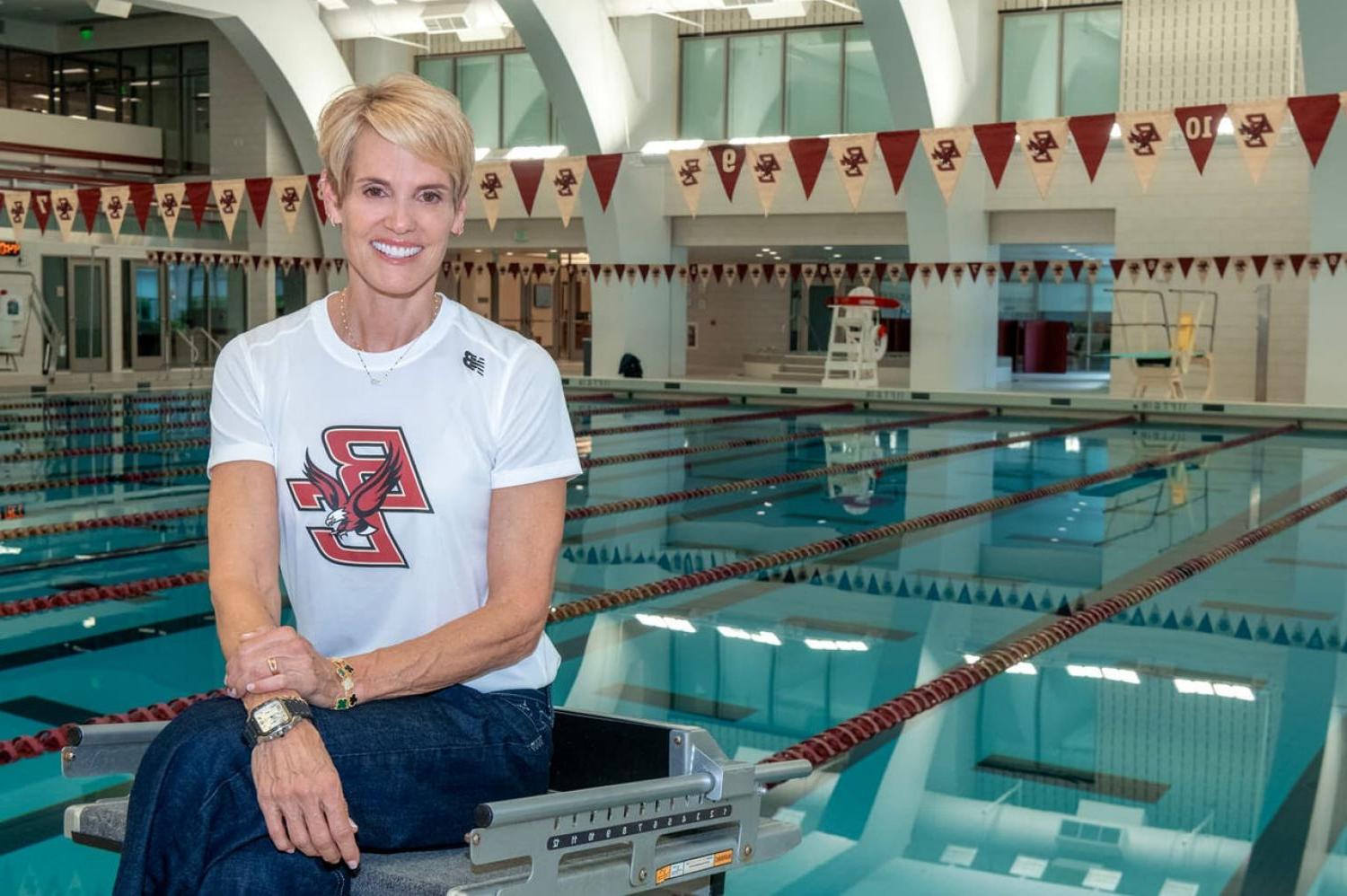 Dara Torres wearing a BC shirt and sitting beside a swimming pool